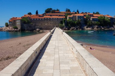 Karadağ 'ın Budva Riviera kentindeki Sveti Stefan adası tatil beldesi ve patikası.