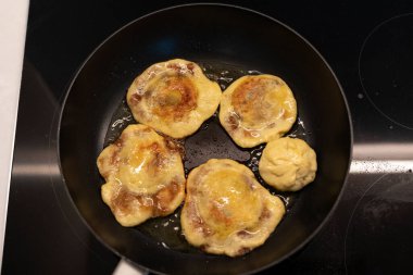 Frying hotteok on the greased pan