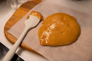 Making giant sugar cookie, dalgona and spatula on the cooking wax paper