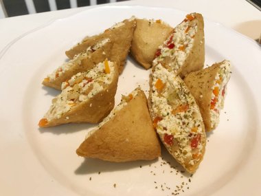 Yubu Chobap(Fried Tofu Rice Balls) with tofu, paprika and parsley