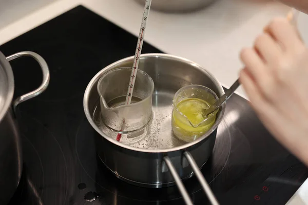 Heat beakers of water and jojoba oil in boiling water, record the temperature with a thermometer