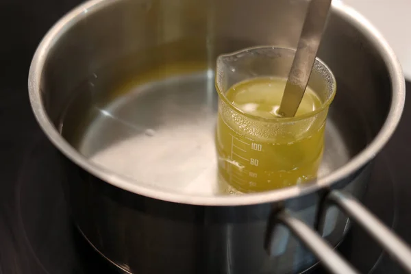 Heat beaker of jojoba oil in boiling water, record the temperature with a thermometer