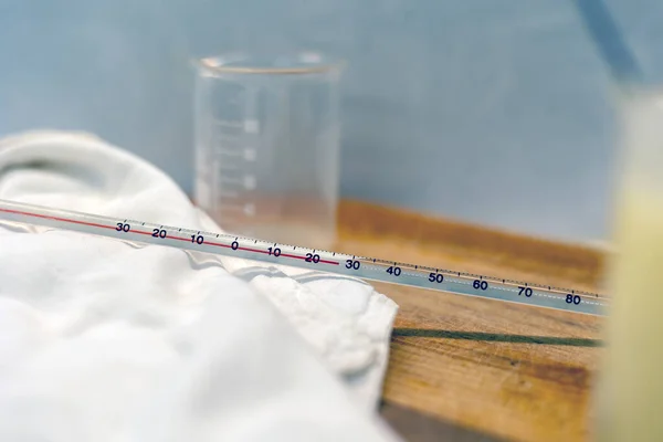 The beakers and the gradations on a thermometer in the laboratory