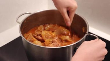 Cooking kimchi stew with a pot