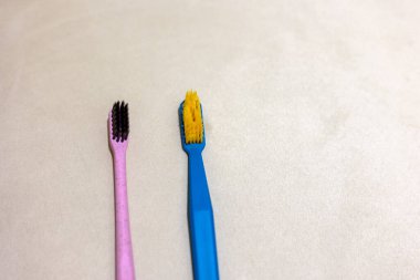 New toothbrush and old toothbrush in bathroom