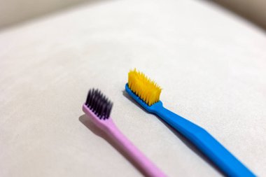 New toothbrush and old toothbrush in bathroom