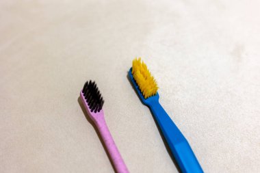 New toothbrush and old toothbrush in bathroom