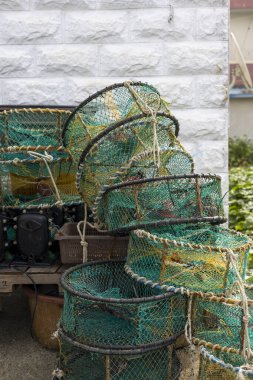 Balık ağları ve balıkçılık araçlarıyla dolu bir liman kasabası.