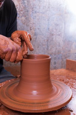 Potter's hand making a vessel