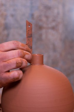 Potter's hand making a vessel