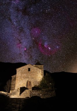 starry sky over a romanesque church in the pyrenees. High quality photo