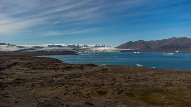 Icelandic lake between mountains and glaciers