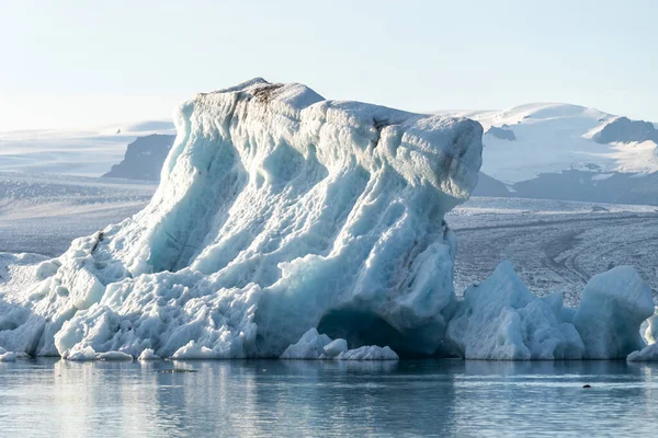 A group of ice water and a mountain in the background