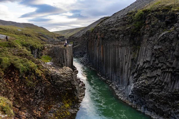 a large waterfall over a body of water with Maletsunyane Falls in the background