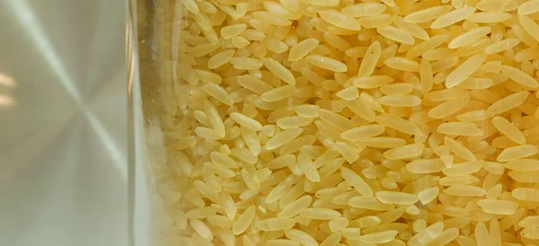 Close-up of Rice on a glass jar with a metallic background