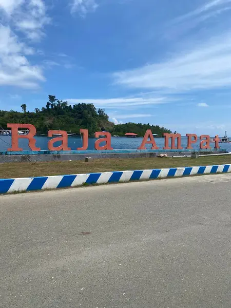 Raja Ampat, road sign with red stripes in the background of the blue sky in spring