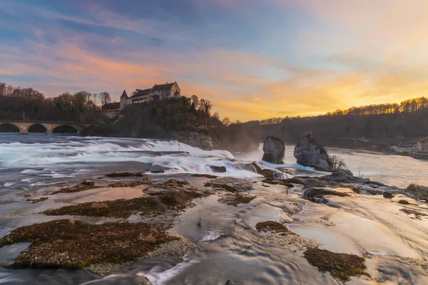 Rhine Falls or Rheinfall, Switzerland panoramic view. Tourist boat in waterfall. Bridge and border between the cantons Schaffhausen and Zrich. The Largest waterfall in Europe.