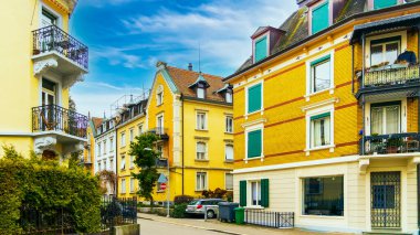Colorful houses with blue winter sky in Zurich, Switzerland. Ancient street with old houses and paving stones road.Traditional Swiss houses in the old town village.