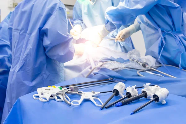 Medical laparoscopic surgery instrument or equipment inside operating room in surgical hospital.Team of Doctor or surgeon do keyhole painless cholecystectomy with blur background and light effect.