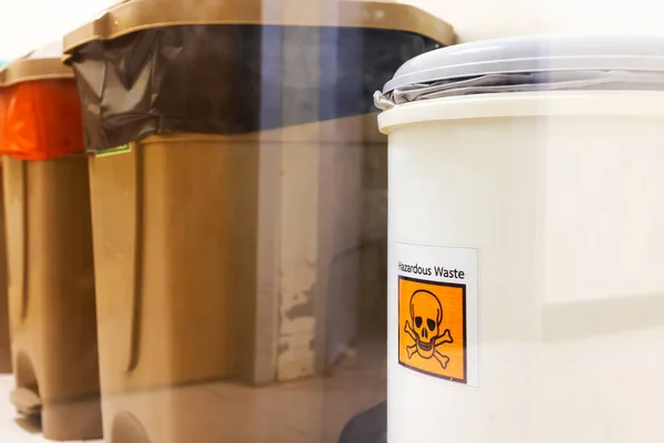 Stock image White plastic bin for hazardous waste in hospital.Trash for dangerous garbage from chemotherapy patients.Medical product waste in hospital.An orange sticker that sign of danger garbage.