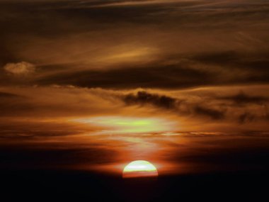 The sun sets the clouds and the sky