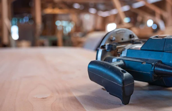 Male carpenter, working in the carpenter's workshop with power h