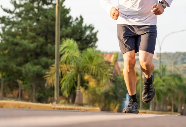 Healthy lifestyle fitness athletes running. Athlete using smartphone and viewing times on watch. 