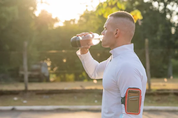 Healthy lifestyle fitness athletes running. Athlete using smartphone and viewing times on watch. 