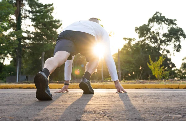 Healthy lifestyle fitness athletes running. Athlete using smartphone and viewing times on watch. 
