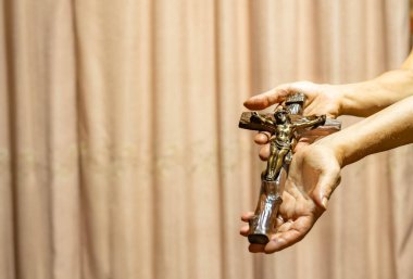 Holy Week religious composition with wooden crucifixion, palm leaf, willow branch, wheat ear. Bible and rosary. Holy week concept, Sunday in copy space.