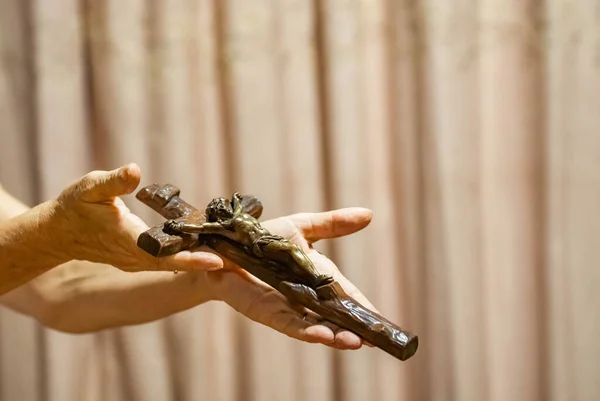 Holy Week religious composition with wooden crucifixion, palm leaf, willow branch, wheat ear. Bible and rosary. Holy week concept, Sunday in copy space.
