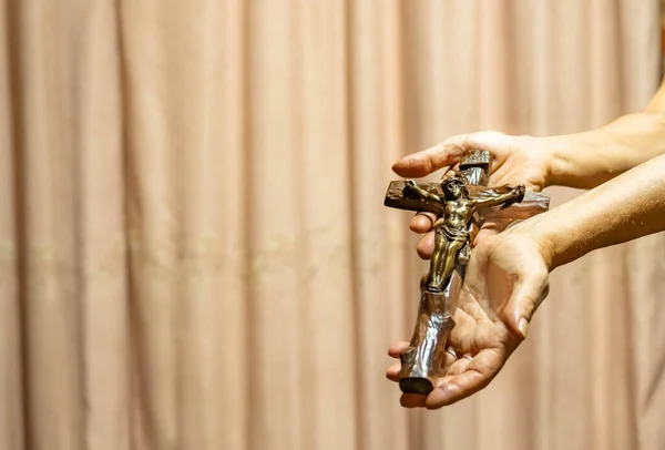 Holy Week religious composition with wooden crucifixion, palm leaf, willow branch, wheat ear. Bible and rosary. Holy week concept, Sunday in copy space.