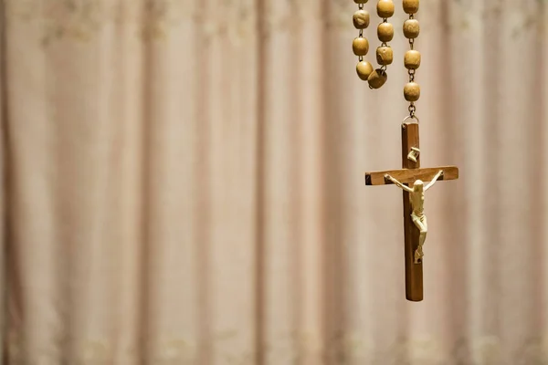 Holy Week religious composition with wooden crucifixion, palm leaf, willow branch, wheat ear. Bible and rosary. Holy week concept, Sunday in copy space.