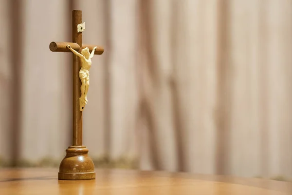 Holy Week religious composition with wooden crucifixion, palm leaf, willow branch, wheat ear. Bible and rosary. Holy week concept, Sunday in copy space.