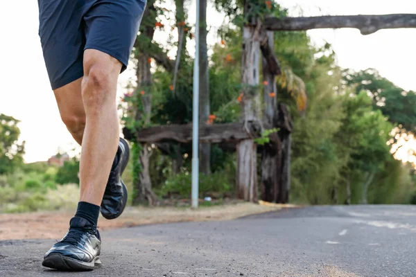 Young male person training, monitoring times with smartphone.
