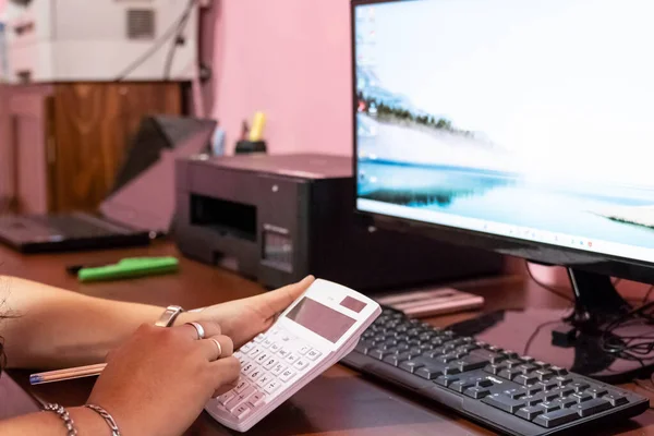 secretary making online purchases with a credit card in the office