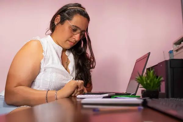 secretary making online purchases with a credit card in the office