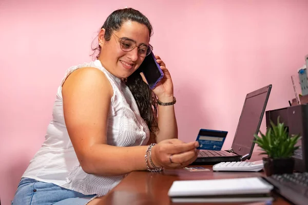 secretary making online purchases with a credit card in the office