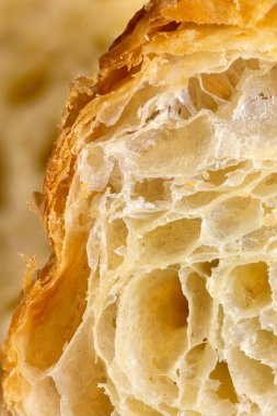Close up shot of the interior of a croissant showing the feuilletage