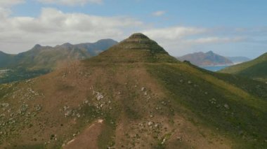 Aerial footage of mountain (Klein Leeukoppie) with town on background