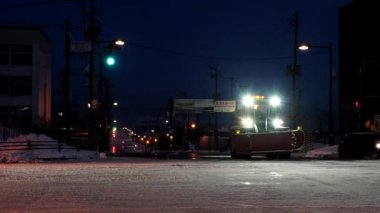 Hokkaido, Japan - January 24, 2023: A snow removal vehicle working at dawn in Nemuro, Hokkaido, Japan 