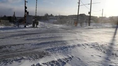 Hokkaido, Japan - January 25, 2023: Taisho rail crossing under strong wind in Nemuro, Hokkaido, Japan.