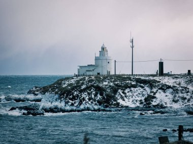 Hokkaido, Japan - January 25, 2023: Cape Nosappu lighthouse in winter storm, Nemuro, Hokkaido, Japan