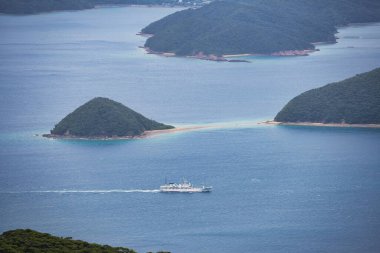Kagoshima, Japan - May 16, 2023: A ferry passing through Oshima strait, between Amami island and Kakeroma island clipart