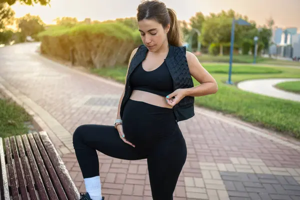 Bankta Bacağı Olan Genç Güzel Bir Kadın Parkta Yürürken Doğum — Stok fotoğraf