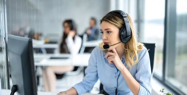 Çağrı merkezindeki bilgisayarda çalışan düşünceli kadın yardım servisi ajanı