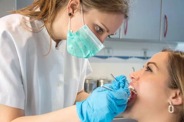 Young Female Dentist Examining Patient Teeth — Stock Photo, Image
