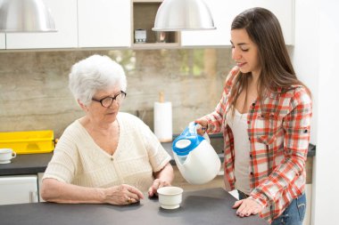Torunu büyükannesine çay getiriyor..
