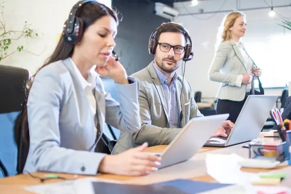 Friendly Male Customer Support Operator Proudly Looking His Female Colleague — Stock Photo, Image