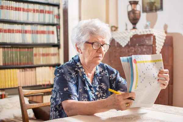Seniorin Sitzt Mit Lesebrille Tisch Und Konzentriert Sich Darauf Hause — Stockfoto